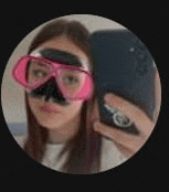 a woman wearing a diving mask is taking a selfie with her cell phone .