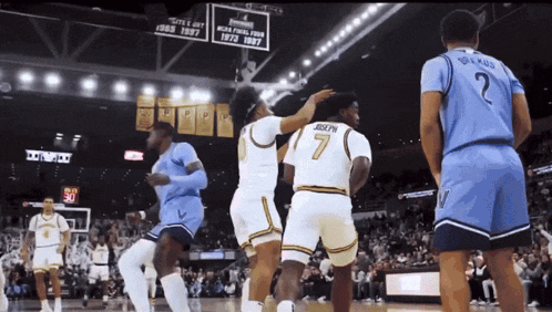 a basketball player with the number 7 on his back is being congratulated by another player