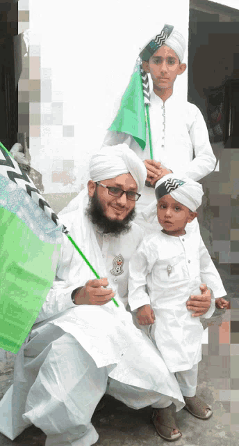 a man and two children pose for a picture with a green flag that says ' aa ' on it