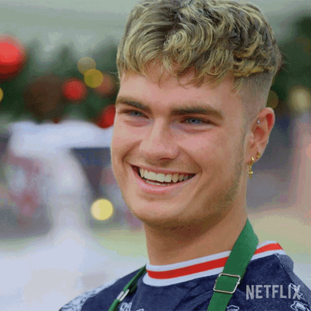 a smiling young man wearing a netflix shirt
