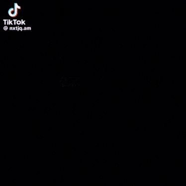 a blurred image of a person holding a cell phone with tiktok written on the bottom