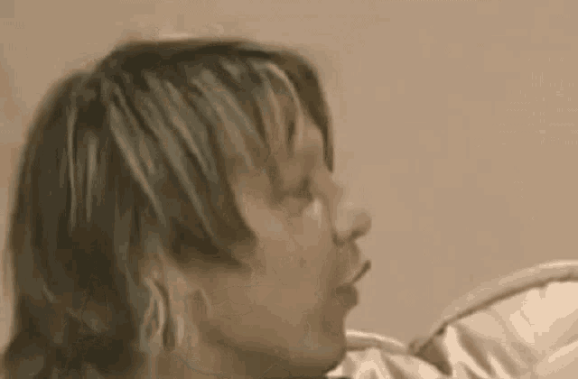 a close up of a man 's face with his mouth open and his eyes closed .