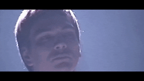 a close up of a man 's face with a blurred background
