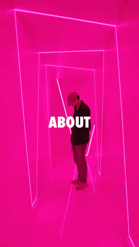 a man is standing in a pink tunnel with the word about written on it