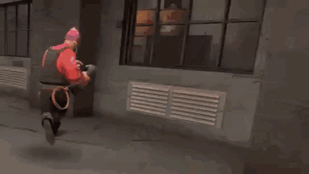 a man in a red shirt is holding a gun in a video game .