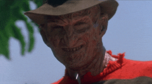 a close up of freddy krueger with a knife in his neck