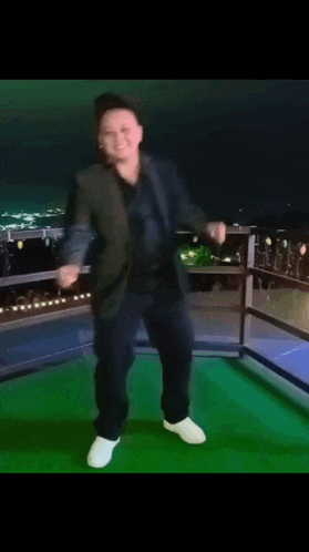 a man in a suit and white shoes is dancing