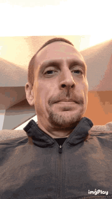 a man with a beard is making a funny face in a gif