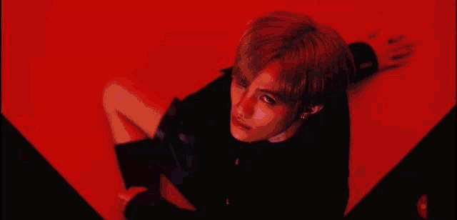 a close up of a person 's neck and chest in a red light .