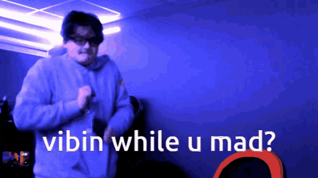 a man is dancing in a dark room with the words vibin while u mad written below him