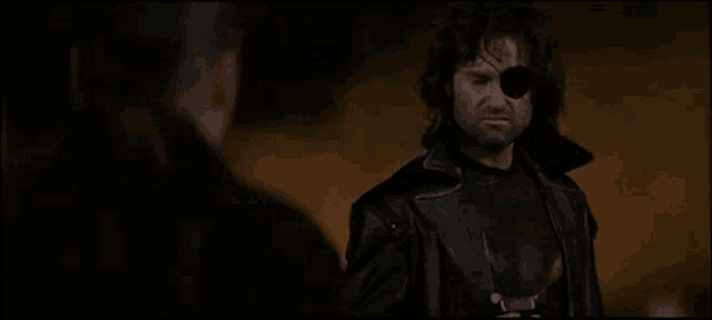 a man in a black leather jacket with a bullet hole in his eye