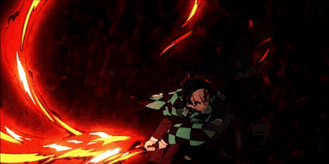 a person in a checkered shirt is surrounded by red and yellow flames .
