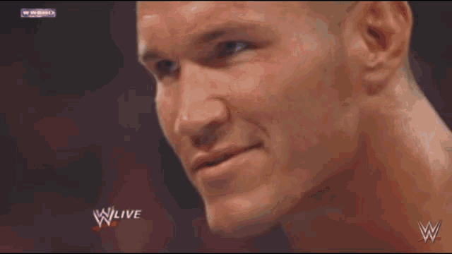 a close up of a man 's face with a w live logo in the background