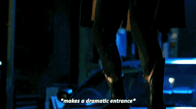 a man in a superhero costume is saying " makes a dramatic entrance " .