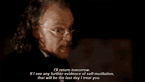 a man with curly hair and glasses says i 'll return tomorrow if i see any further evidence of self-mutilation