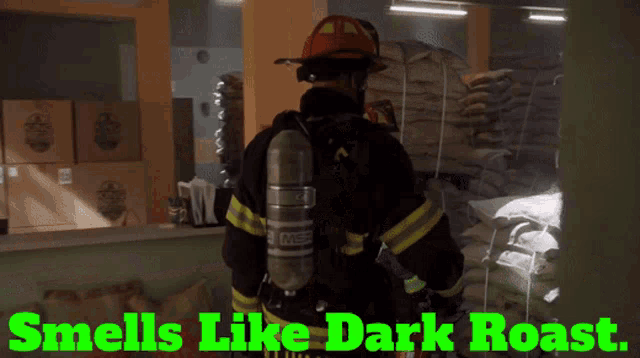 a fireman in a warehouse with the words " smells like dark roast " below him