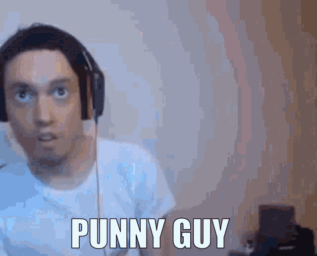 a man wearing headphones says punny guy in front of a white wall .