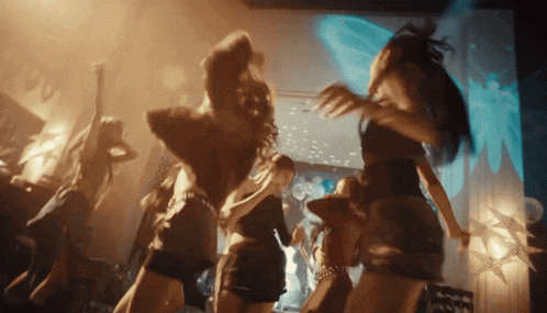 a group of women are dancing in a club