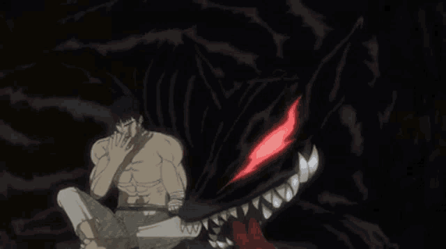 a man is sitting next to a black monster with red eyes and teeth .