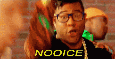 a man wearing glasses and a necklace with the word nooice written on it