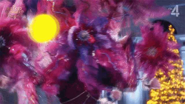 a painting of purple flowers with a yellow light in the background .