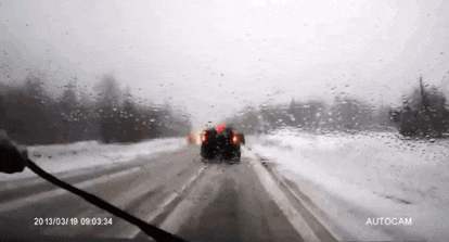 a car is driving down a snowy road with a time stamp of 2013/03/19