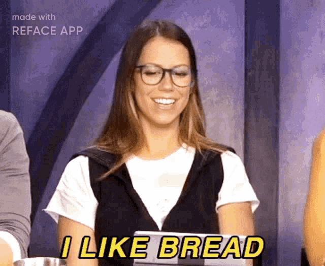 a woman with glasses says i like bread in a video