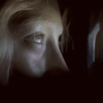 a close up of a woman 's face with her eyes closed