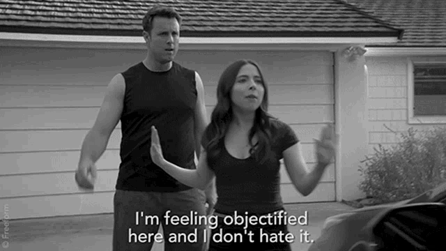 a man and a woman standing in front of a garage with the woman saying i 'm feeling objectified