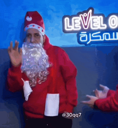 a man dressed as santa claus is waving in front of a neon sign that says level 6