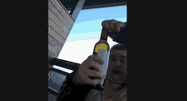 a woman is holding a bottle of wine with a label that says ' chateau ' on it
