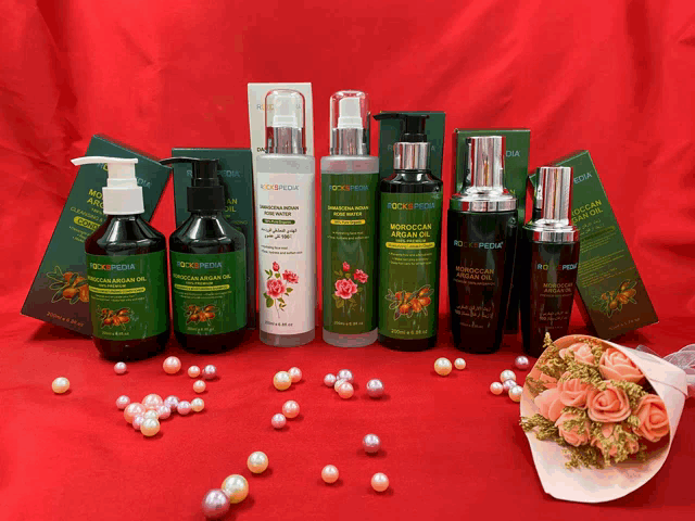 several bottles of moroccan argan oil are lined up on a table
