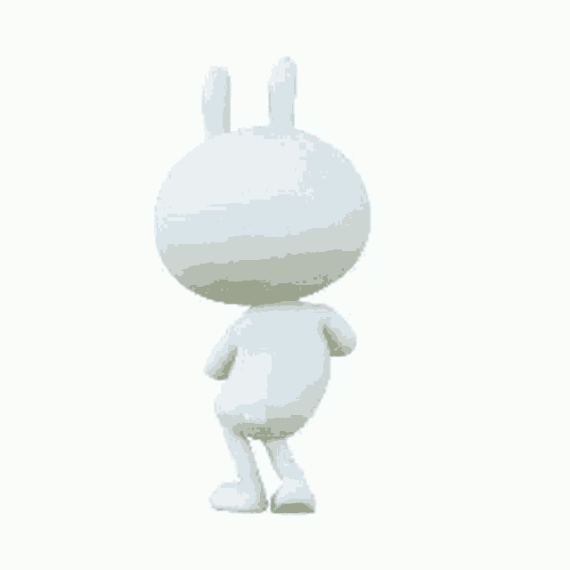 a white rabbit is standing on its hind legs and looking at the camera .