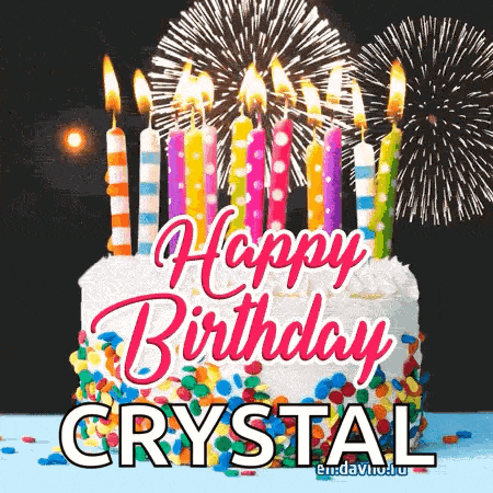 a birthday cake with candles and fireworks and the name crystal