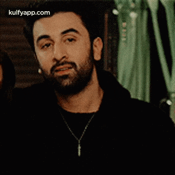 a man with a beard and a woman are standing next to each other .
