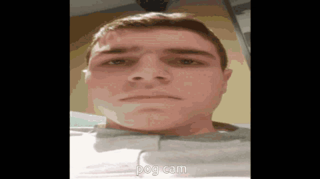 a close up of a man 's face with the words pog cam written below it
