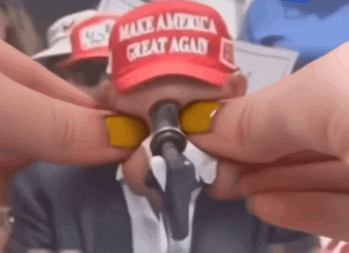 a man wearing a make america great again hat
