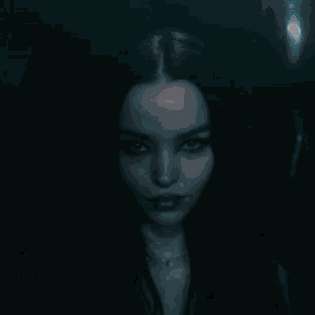 a close up of a woman 's face with long black hair