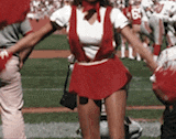 a cheerleader in a red outfit with the number 6 on her shirt