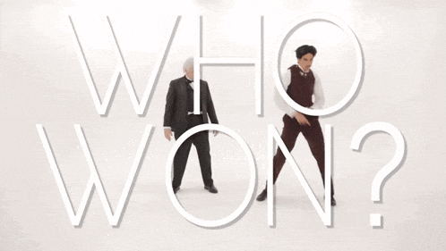 two men are standing in front of the words who 's next ?