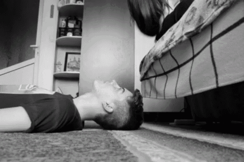 a man is laying on the floor with his head on the floor