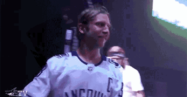 a man in a white jersey with the letter c on the front
