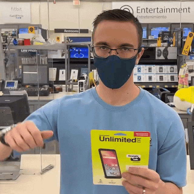a man wearing a mask is holding an unlimited phone