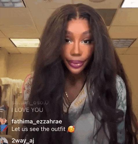 a woman with long hair says i love you in a room