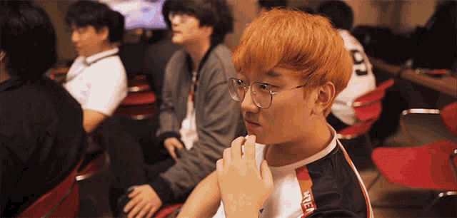 a man with red hair wears glasses and a shirt with the number 97 on the back of it