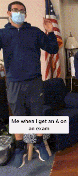 a man wearing a mask is standing in front of an american flag