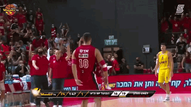 a basketball player wearing a red number 18 jersey