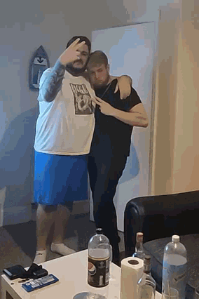 two men standing next to each other one of whom is wearing a shirt that says lucky