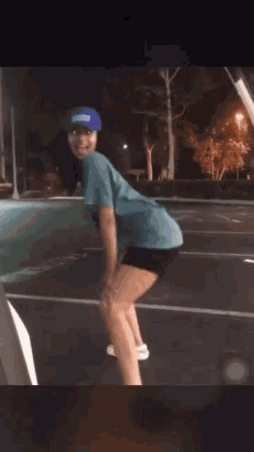 a girl wearing a blue hat that says jacksonville on it