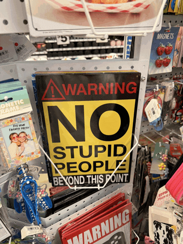 a sign that says warning no stupid people beyond this point on it